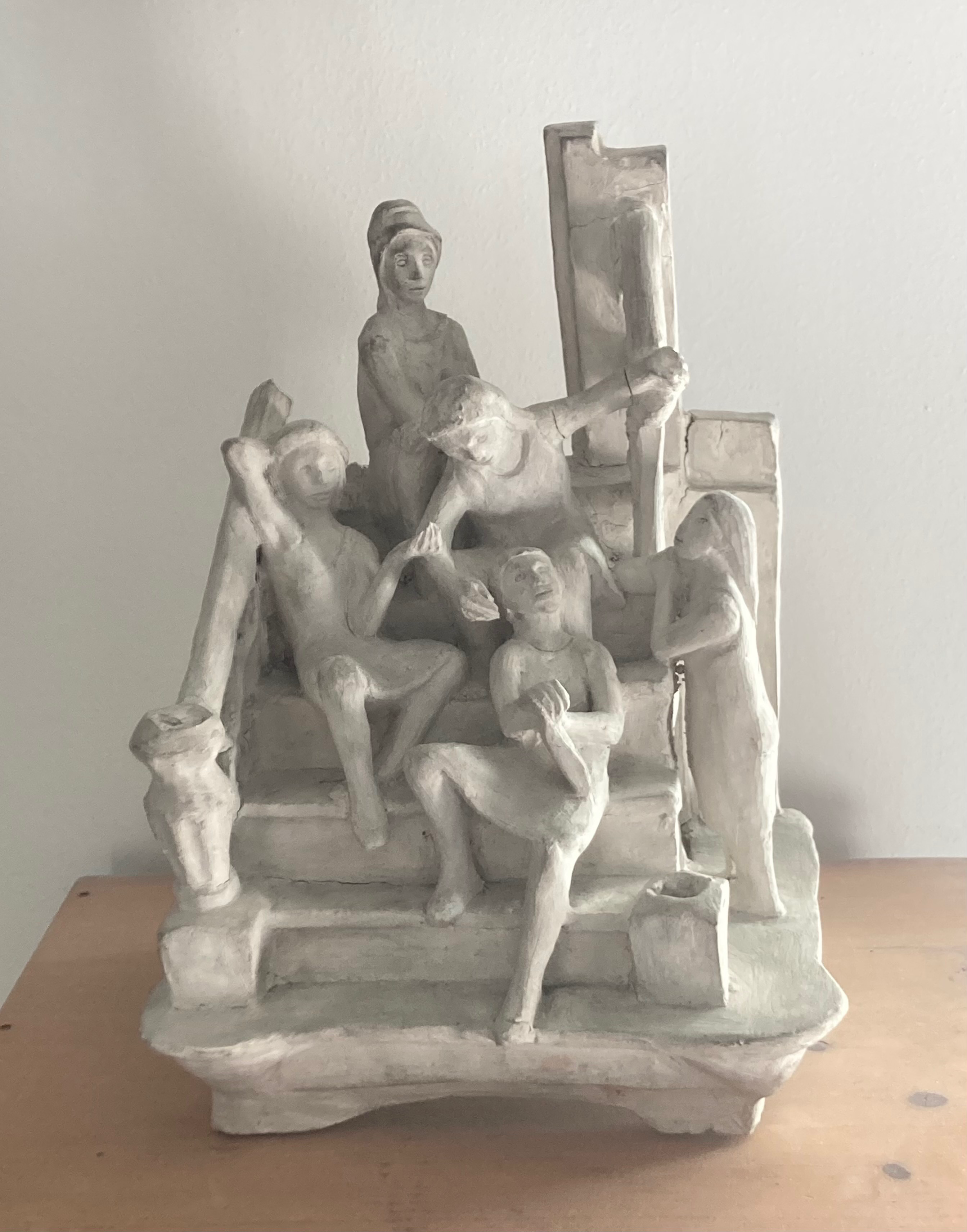 Ceramic sculpture of people gathered on a stoop