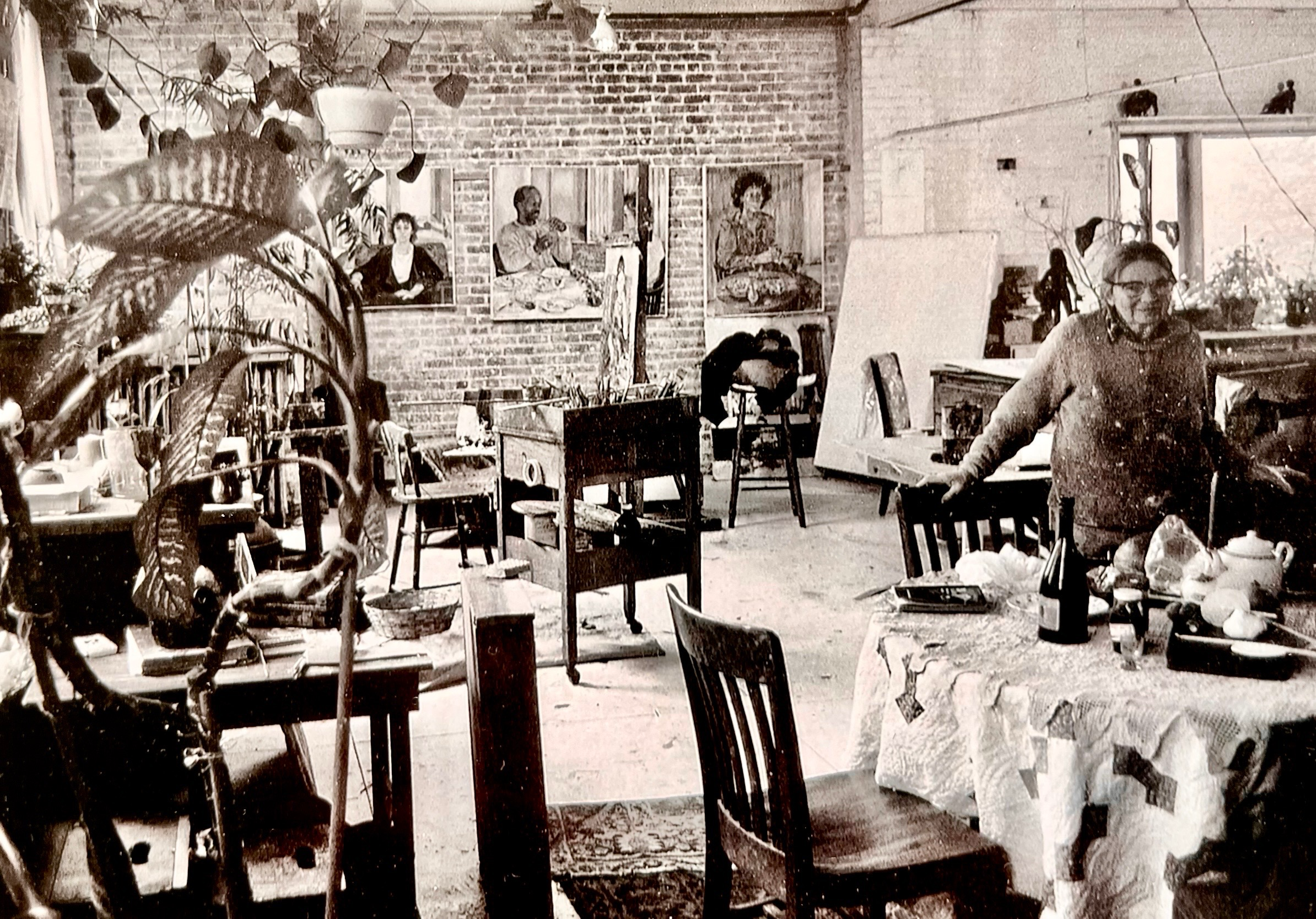 Edith Kramer seated at a table in her studio